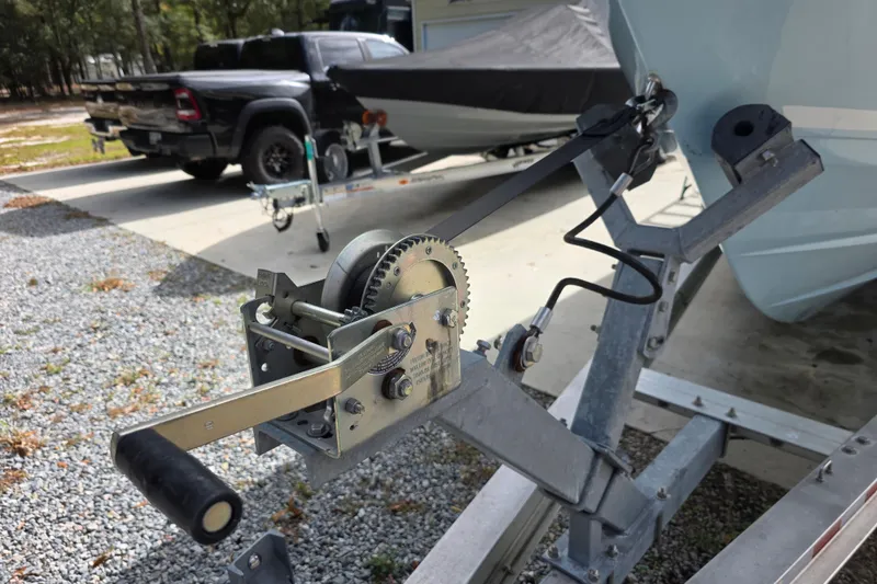 Slide: The Image of Trailer winch for 2022 Cobia 320 Center Console boat, parked on gravel driveway. - 31