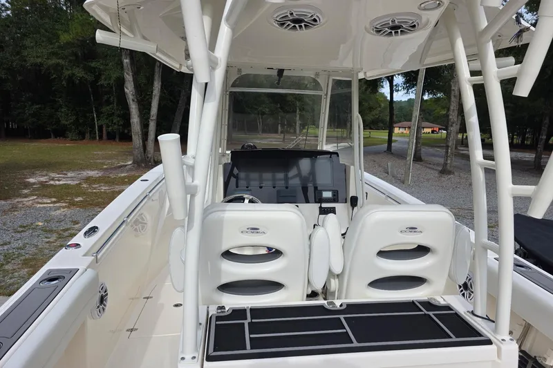 Slide: The Image of 2022 Cobia 320 Center Console boat interior with dual seats and navigation equipment. - 5
