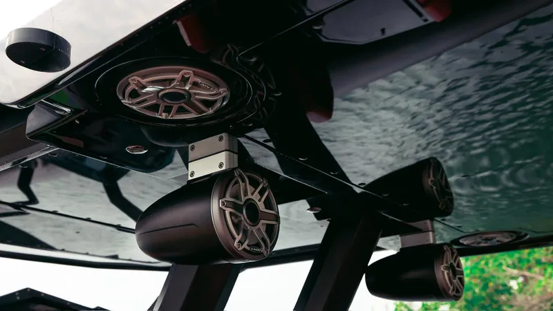 Slide: The Image of High-quality speakers on Skipper-BSK 42 boat, 2023 model, under a sleek black canopy. - 31