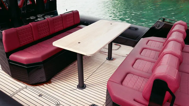 Slide: The Image of Luxurious seating area on 2023 Skipper-BSK 42 boat with red upholstery and wooden table. - 33
