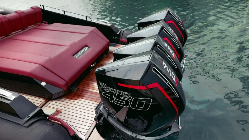 Slide: The Image of Four powerful outboard engines on a 2023 Skipper-BSK 42 boat, docked on calm water. - 36