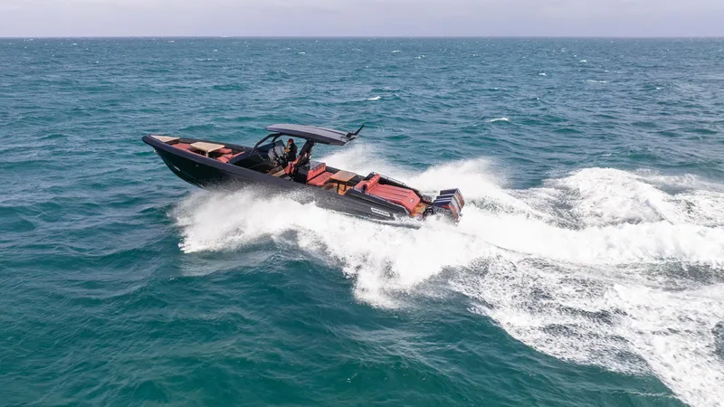 Slide: The Image of 2023 Skipper-BSK 42 boat cruising on open sea, creating white waves. - 37