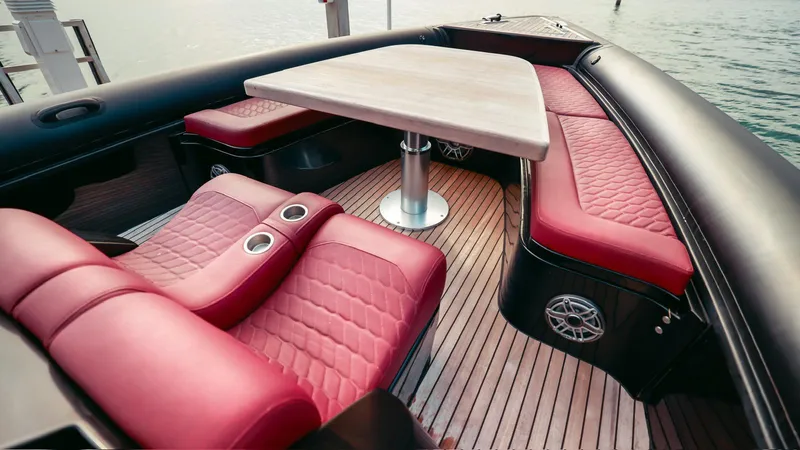 Slide: The Image of Luxurious 2023 Skipper-BSK 42 boat interior with red leather seating and wooden deck. - 23