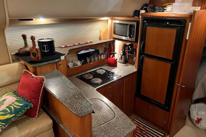 Slide: The Image of Luxurious kitchen interior of 2004 Meridian 408 Motoryacht with modern appliances and elegant design. - 12