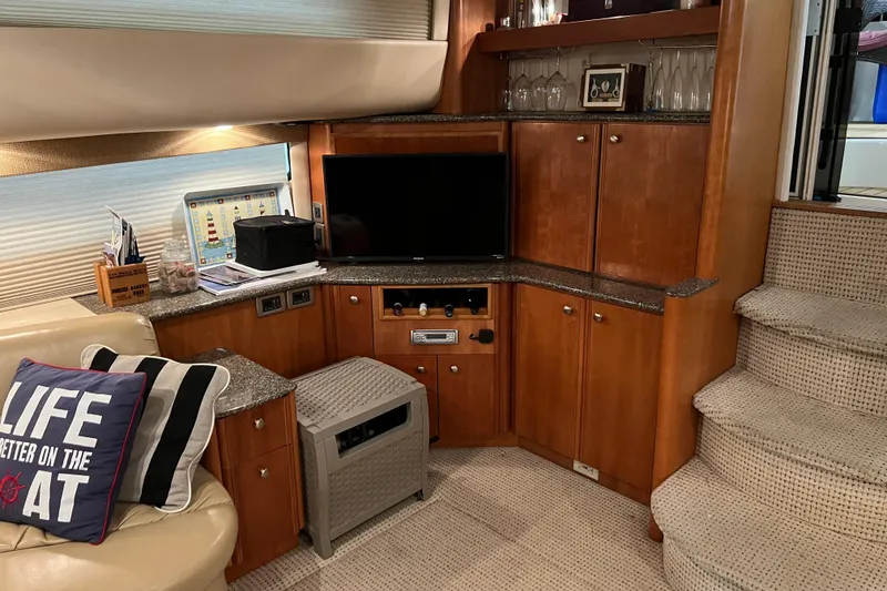 Slide: The Image of Luxurious interior of 2004 Meridian 408 Motoryacht with TV, cabinets, and cozy seating. - 13