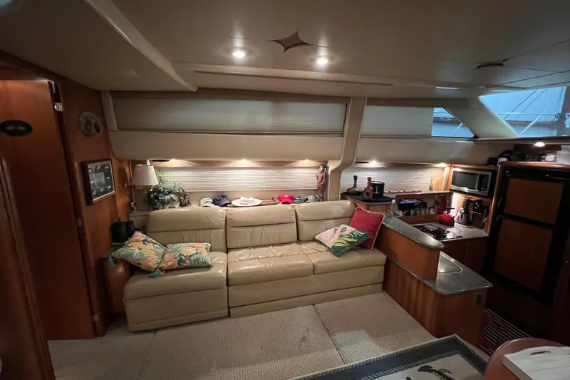 Slide: The Image of Luxurious interior of 2004 Meridian 408 Motoryacht with beige leather sofa and kitchenette. - 15