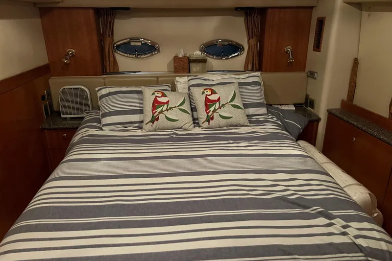 Slide: The Image of Luxurious bedroom in 2004 Meridian 408 Motoryacht with striped bedding and parrot pillows. - 17