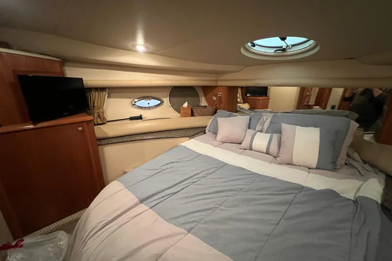 Slide: The Image of Luxurious bedroom interior of 2004 Meridian 408 Motoryacht with cozy bedding and porthole windows. - 19