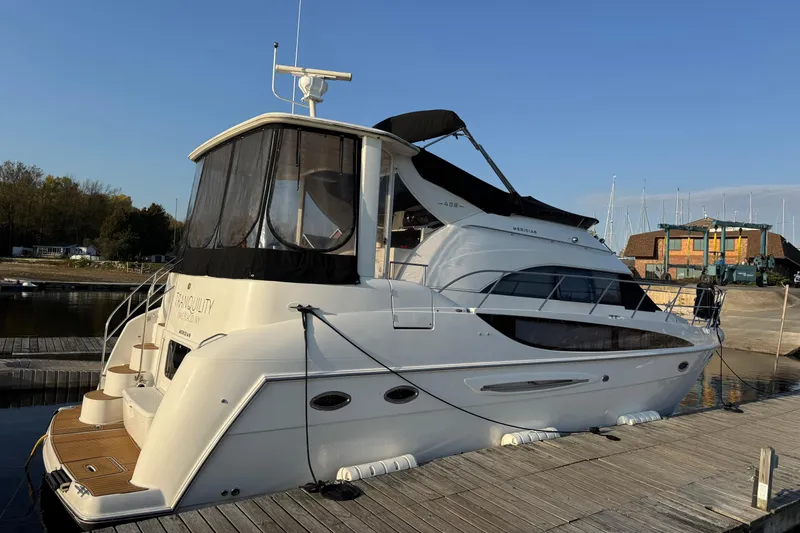 Slide: The Image of 2004 Meridian 408 Motoryacht docked at a marina under clear blue skies. - 2