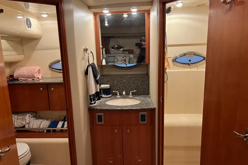 Slide: The Image of 2004 Meridian 408 Motoryacht bathroom with sink, mirror, and shower area. - 22