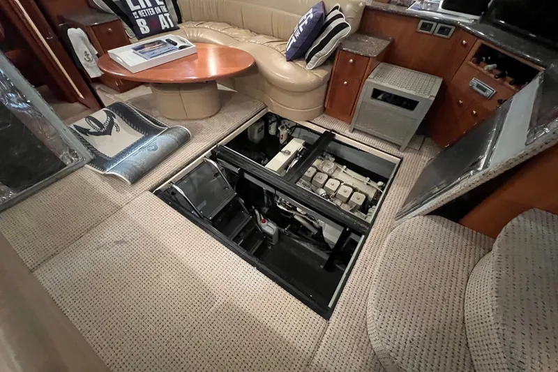 Slide: The Image of 2004 Meridian 408 Motoryacht interior with open engine access panel, showcasing luxurious seating. - 23