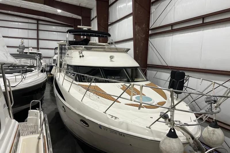 Slide: The Image of 2004 Meridian 408 Motoryacht in storage, showcasing sleek design and spacious deck. - 4