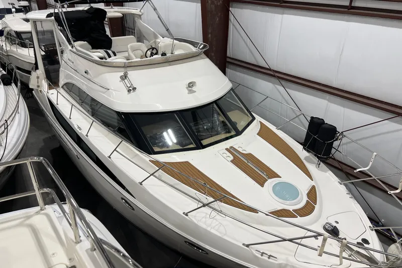 Slide: The Image of 2004 Meridian 408 Motoryacht in storage, showcasing sleek design and spacious deck. - 5