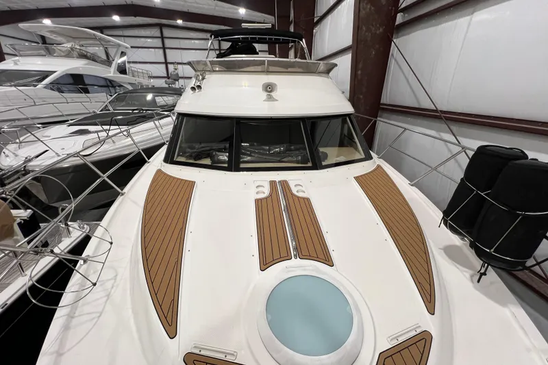 Slide: The Image of 2004 Meridian 408 Motoryacht in indoor storage, showcasing sleek design and spacious deck. - 6