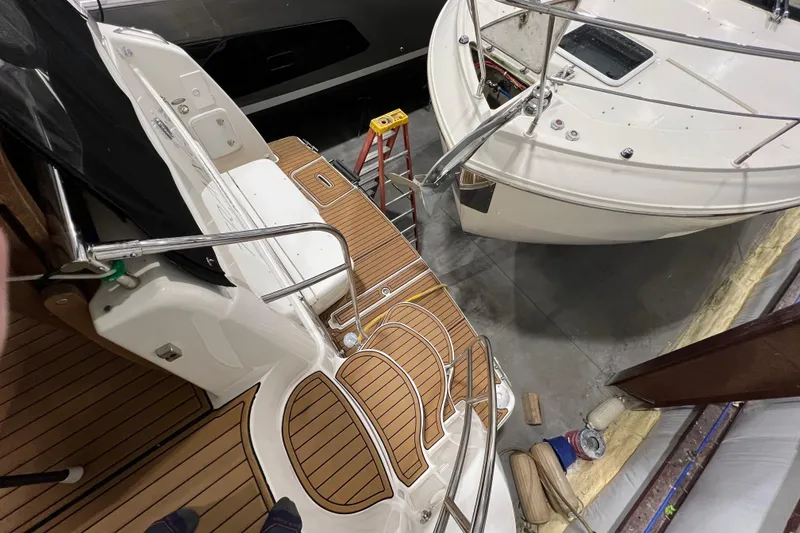 Slide: The Image of 2004 Meridian 408 Motoryacht in a storage facility, showcasing deck and railing details. - 7