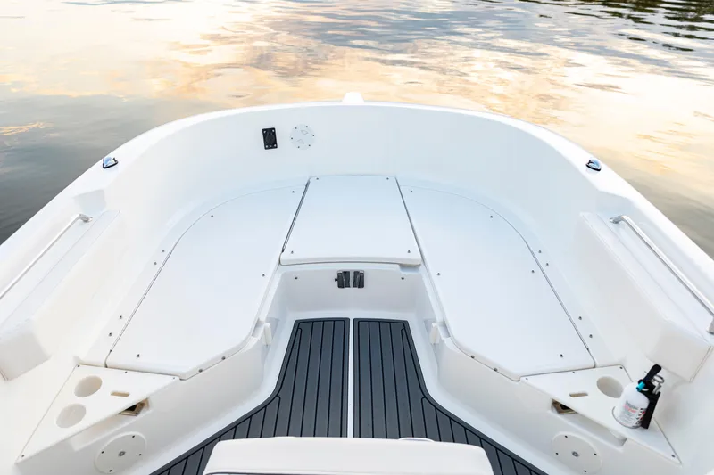 Slide: The Image of 2026 Bayliner Trophy T22CC boat interior with sleek white seating and modern design. - 16