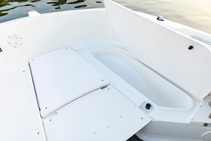 Slide: The Image of 2026 Bayliner Trophy T22CC boat interior with open storage compartment. - 22