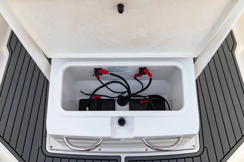 Slide: The Image of Battery compartment of 2026 Bayliner Trophy T22CC boat, featuring wiring and connections. - 26