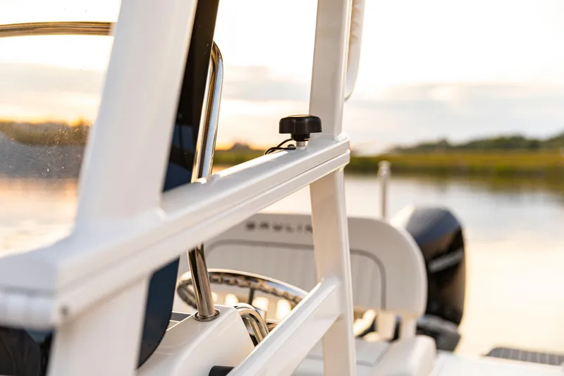 Slide: The Image of 2026 Bayliner Trophy T22CC boat detail with serene water backdrop. - 28