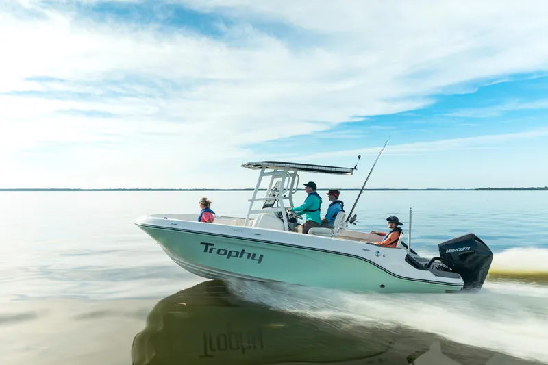 Slide: The Image of 2026 Bayliner Trophy T22CC boat cruising on calm waters under a clear sky. - 3