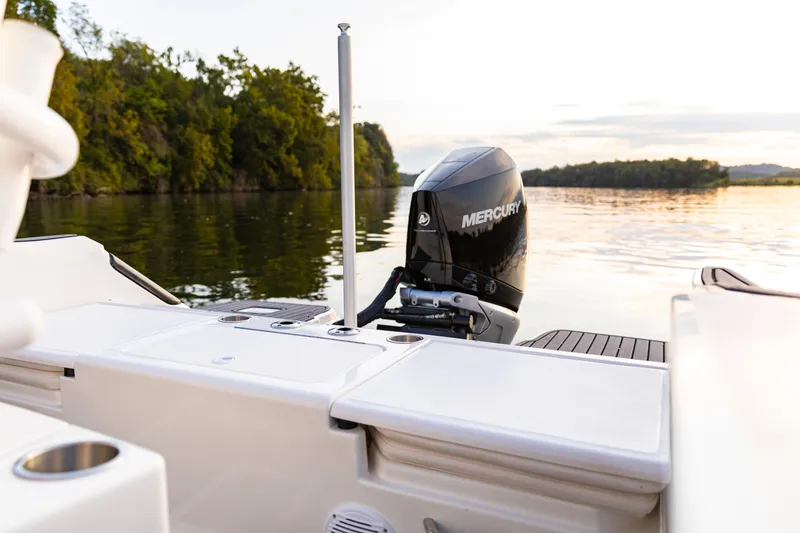 Slide: The Image of 2026 Bayliner Trophy T22CC boat with Mercury engine on calm lake at sunset. - 37