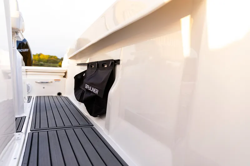 Slide: The Image of 2026 Bayliner Trophy T22CC boat interior with storage bag and sleek flooring. - 40