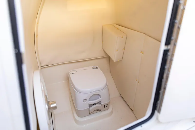 Slide: The Image of 2026 Bayliner Trophy T22CC boat interior with compact marine toilet. - 42
