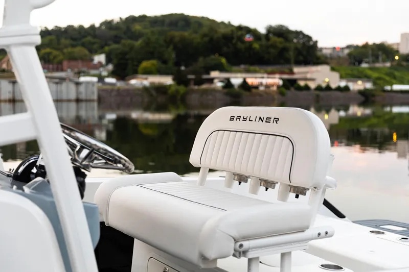 Slide: The Image of 2026 Bayliner Trophy T22CC boat interior with white seating by a calm lake. - 5