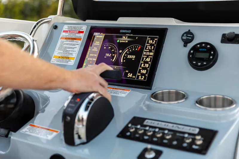 Slide: The Image of Dashboard of 2026 Bayliner Trophy T22CC boat with touchscreen controls and gauges. - 7