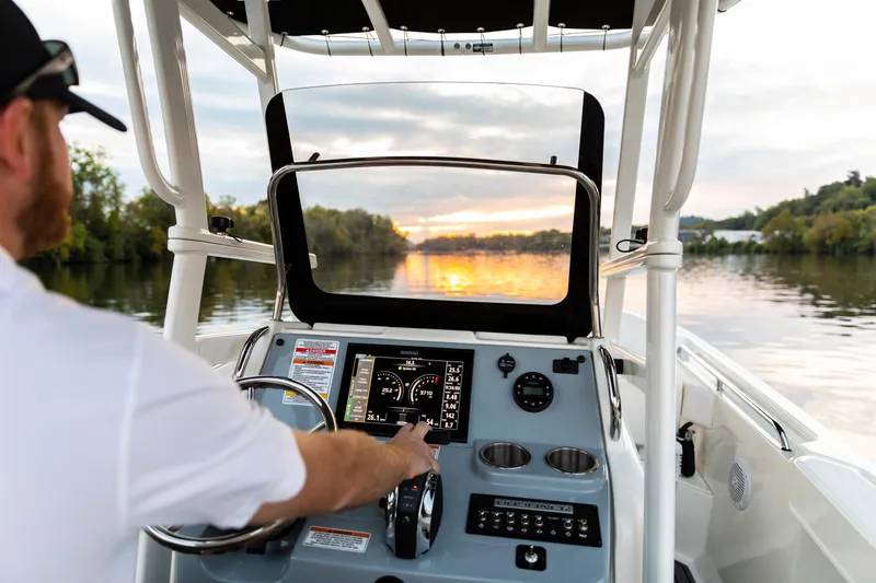 Slide: The Image of 2026 Bayliner Trophy T22CC boat dashboard with sunset view on the water. - 8
