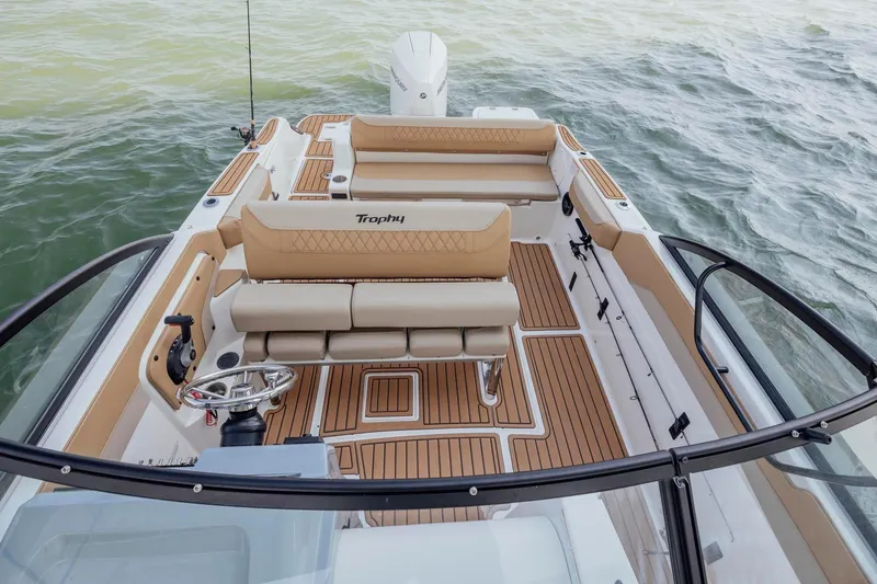 The Image of 2026 Bayliner Trophy T22SC boat interior with tan seating and wood-style flooring. - 1