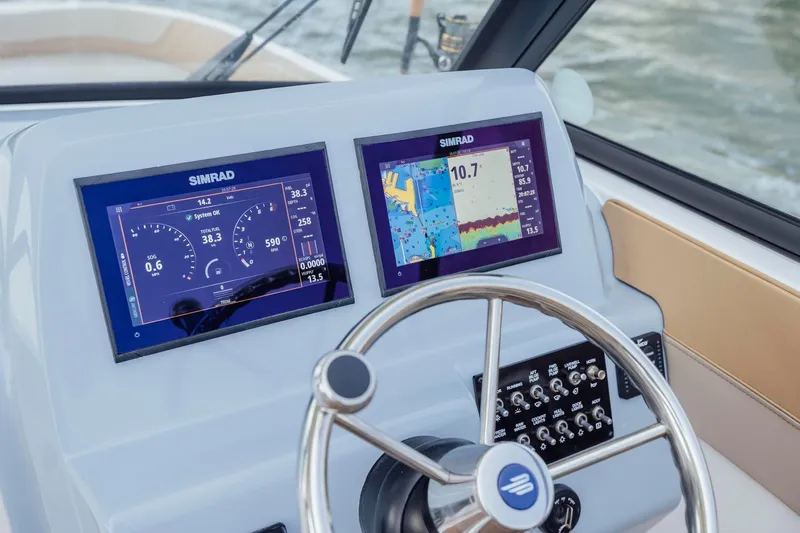 Slide: The Image of Dashboard of 2026 Bayliner Trophy T22SC with dual Simrad displays and steering wheel. - 18