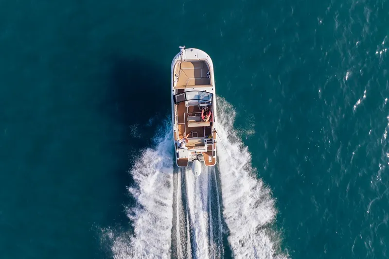 Slide: The Image of Aerial view of 2026 Bayliner Trophy T22SC boat cruising on open water. - 27