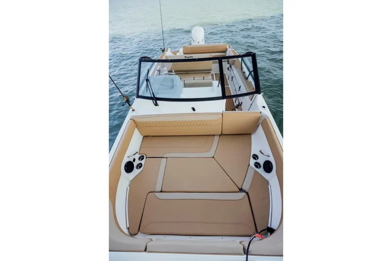 Slide: The Image of 2026 Bayliner Trophy T22SC boat interior with tan seating on water. - 3