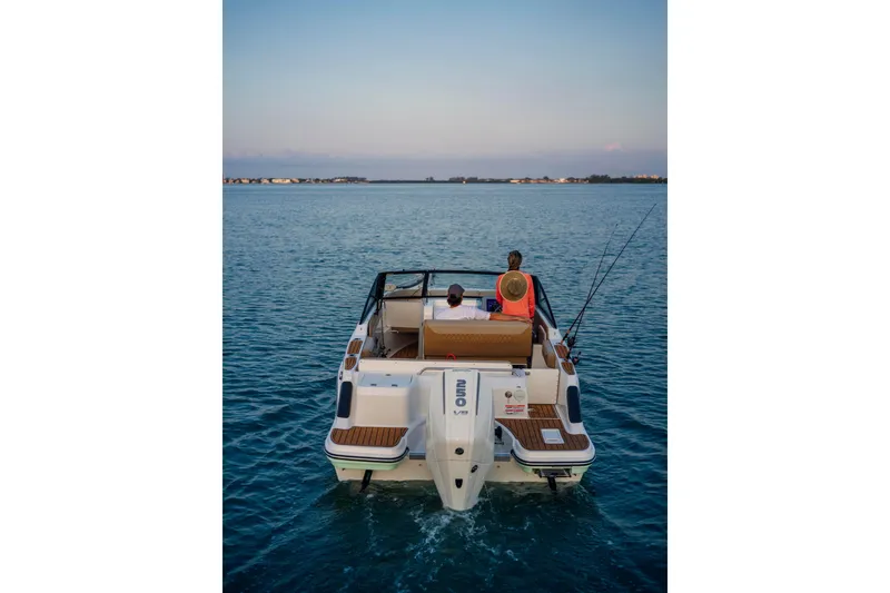 Slide: The Image of 2026 Bayliner Trophy T22SC boat on calm water, two people fishing. - 35