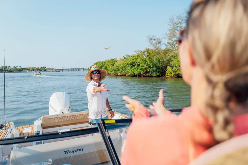 Slide: The Image of Man enjoying a sunny day on a 2026 Bayliner Trophy T22SC boat. - 39