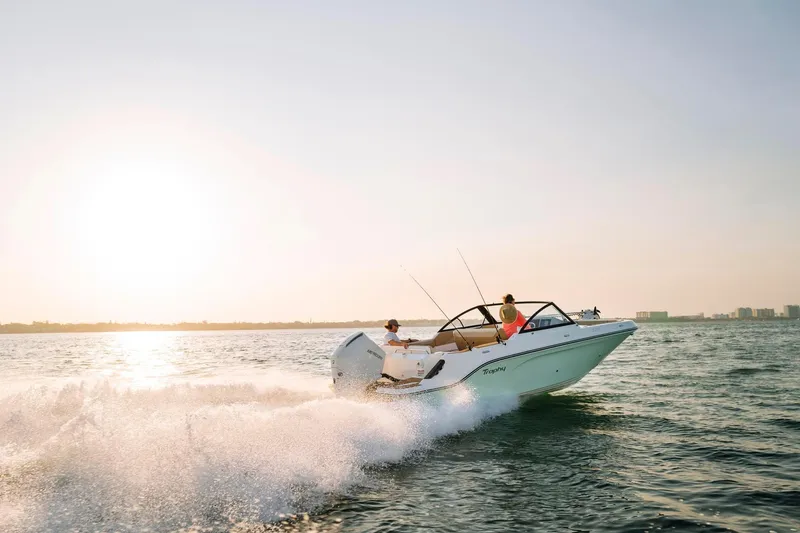 Slide: The Image of 2026 Bayliner Trophy T22SC boat cruising on open water at sunset. - 41