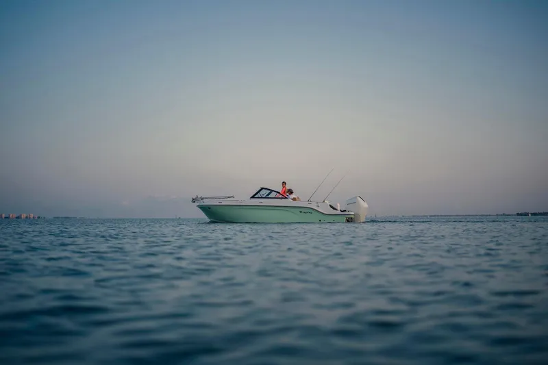 Slide: The Image of 2026 Bayliner Trophy T22SC boat on calm water at sunset. - 42