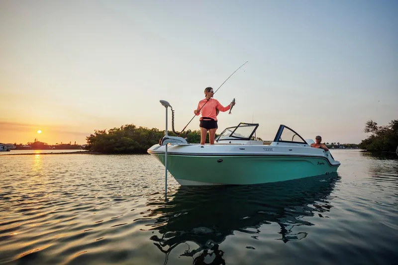 Slide: The Image of 2026 Bayliner Trophy T22SC boat with people fishing at sunset on calm waters. - 43