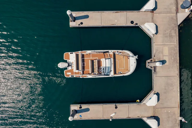 Slide: The Image of Aerial view of 2026 Bayliner Trophy T22SC docked at marina. - 8