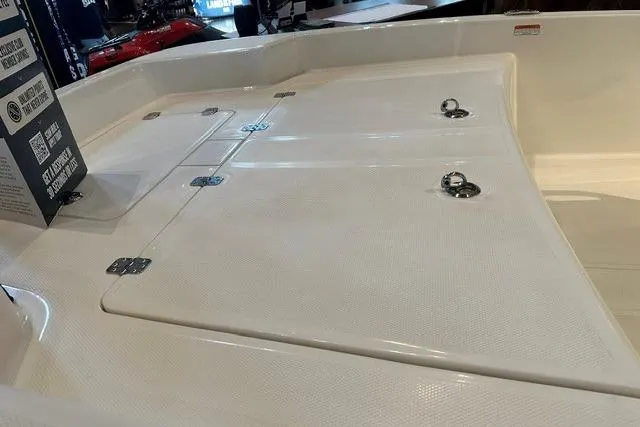 Slide: The Image of 2026 Mako Pro Skiff 15 CC boat deck with storage compartments and tie-down rings. - 9