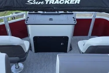 Slide: The Image of 2026 Sun Tracker Fishin' Barge 22 DLX interior with seating and console. - 74