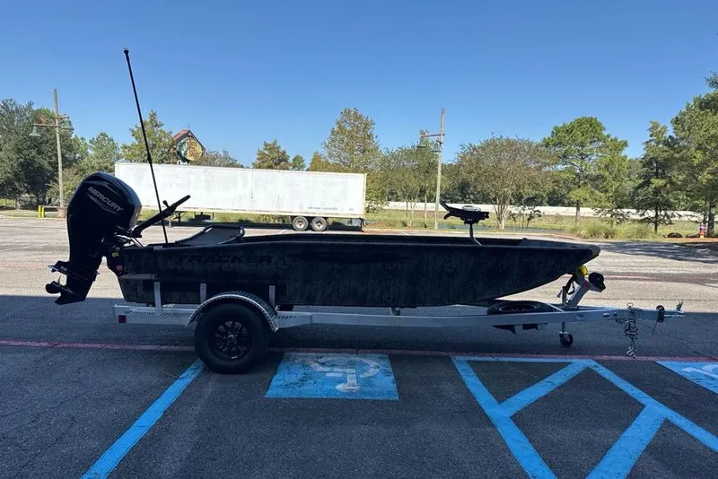 Slide: The Image of 2026 Tracker Grizzly 1650 T Prairie Wings Edition boat on trailer in parking lot. - 2