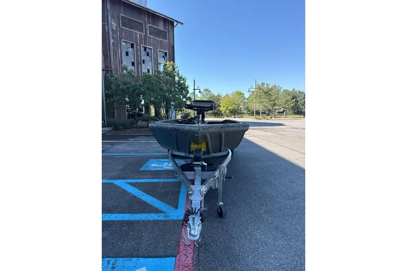 Slide: The Image of 2026 Tracker Grizzly 1650 T Prairie Wings Edition boat on trailer in parking lot. - 3