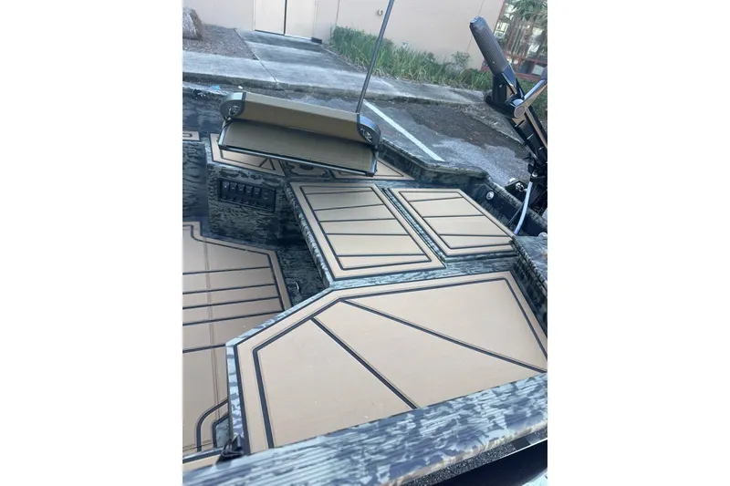 Slide: The Image of 2026 Tracker Grizzly 1650 T Prairie Wings Edition boat interior with camo design and padded flooring. - 6