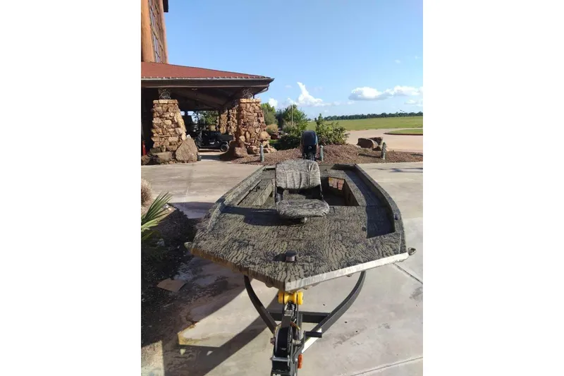 Slide: The Image of 2026 Tracker Grizzly 1654 T Sportsman boat on trailer, outdoor setting. - 41