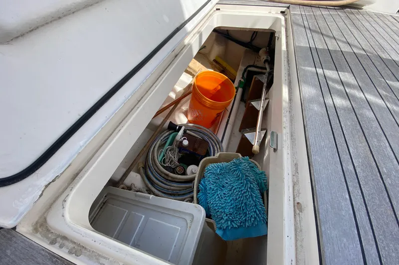 Slide: The Image of Storage compartment on 2000 Riviera 4000 boat with cleaning supplies and equipment. - 12