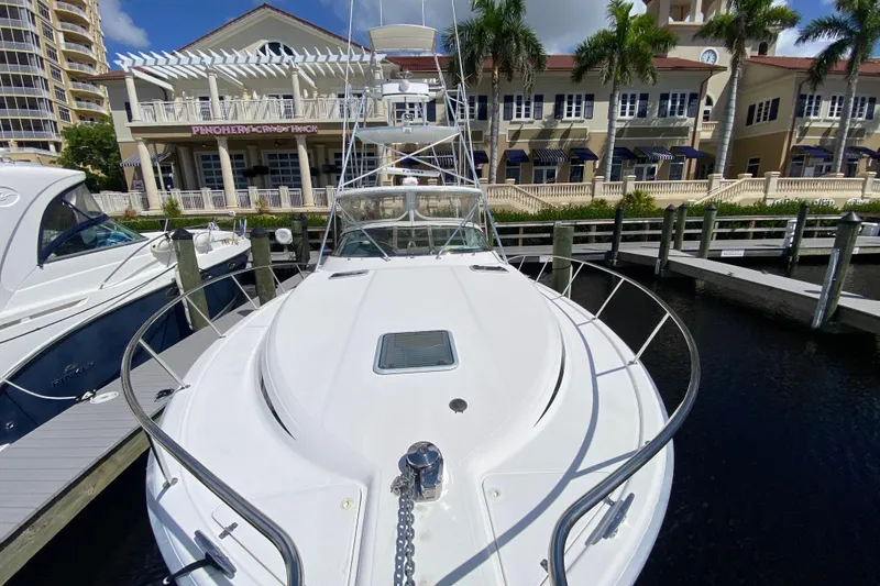 Slide: The Image of Riviera 4000 yacht docked at marina, showcasing sleek design and waterfront buildings. - 21