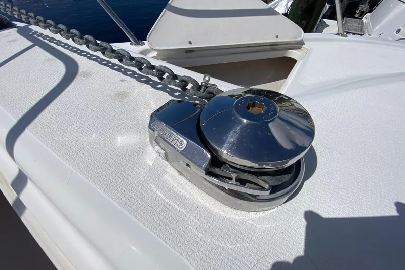 Slide: The Image of Anchor windlass on 2000 Riviera 4000 yacht deck, with chain and polished metal finish. - 23