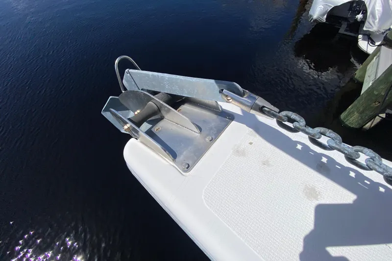 Slide: The Image of Anchor and chain on a 2000 Riviera 4000 boat, docked by the water. - 24